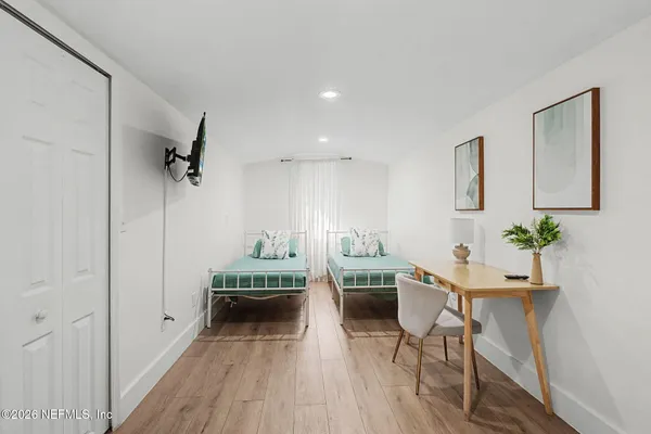 a view of a room with furniture and wooden floor