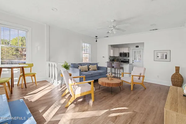 a living room with fireplace furniture and a wooden floor