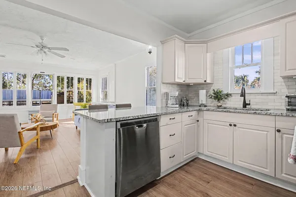 a kitchen with a sink stove and cabinets