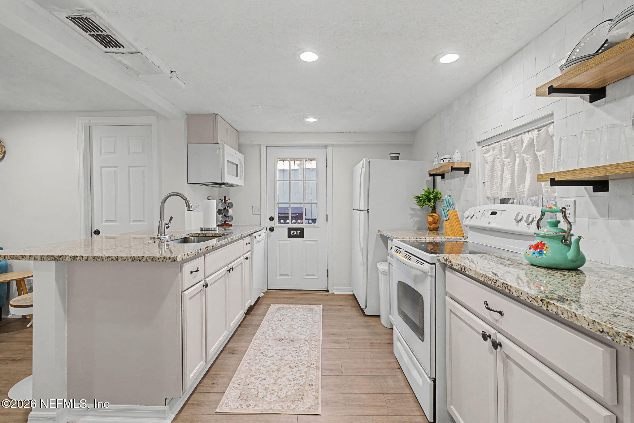 16 Myrtle Avenue St. Augustine, FL 32084 - Photo 9 of 47 a large kitchen with stainless steel appliances granite countertop lots of counter top space and white cabinets