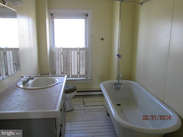 11003 Keymar Road Woodsboro, MD 21798 - Photo 3 of 15 a bathroom with a tub sink and mirror