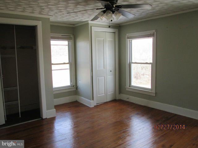 11003 Keymar Road Woodsboro, MD 21798 - Photo 4 of 15 an empty room with wooden floor and windows