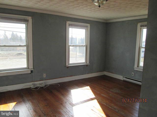 11003 Keymar Road Woodsboro, MD 21798 - Photo 6 of 15 an empty room with wooden floor and windows