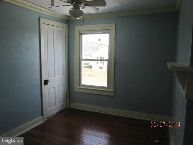 11003 Keymar Road Woodsboro, MD 21798 - Photo 8 of 15 a view of an empty room with wooden floor and a window