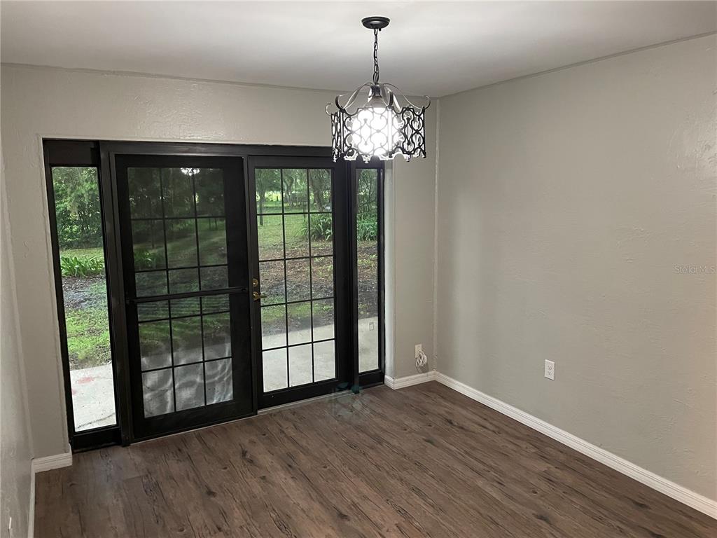 3267 Rackley Road Brooksville, FL 34604 - Photo 14 of 23 a view of an empty room with wooden floor and a window