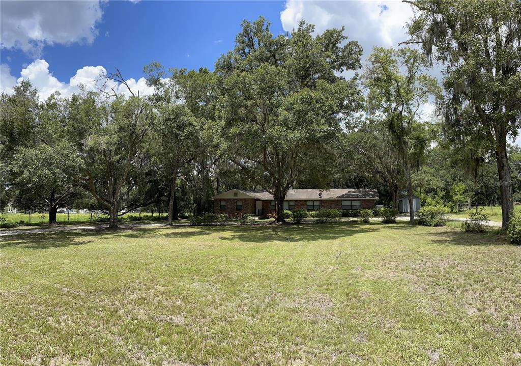 3267 Rackley Road Brooksville, FL 34604 - Photo 3 of 23 a view of a swimming pool with a house in the background