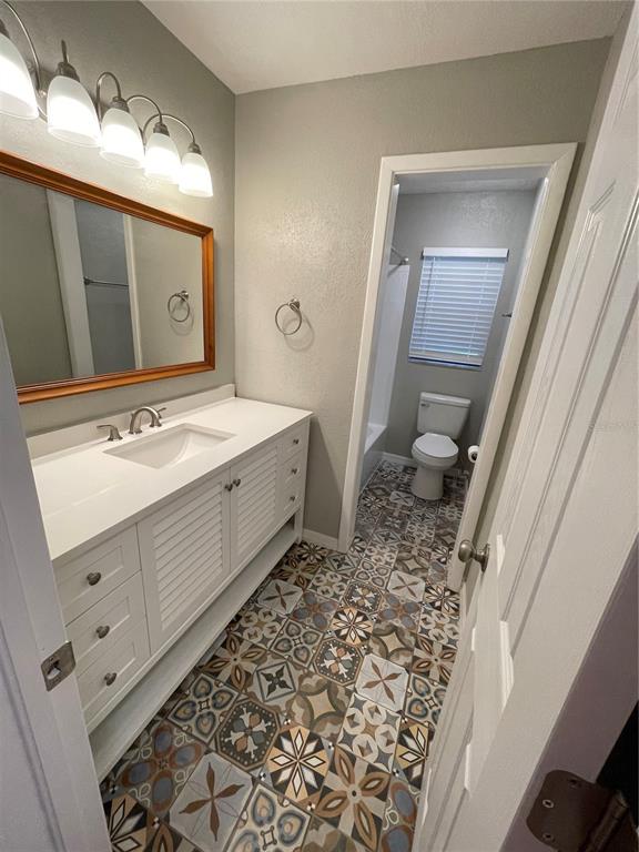 3267 Rackley Road Brooksville, FL 34604 - Photo 6 of 23 a bathroom with a sink a toilet and a mirror