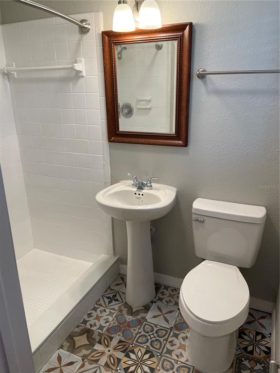 3267 Rackley Road Brooksville, FL 34604 - Photo 7 of 23 a bathroom with a toilet sink and mirror