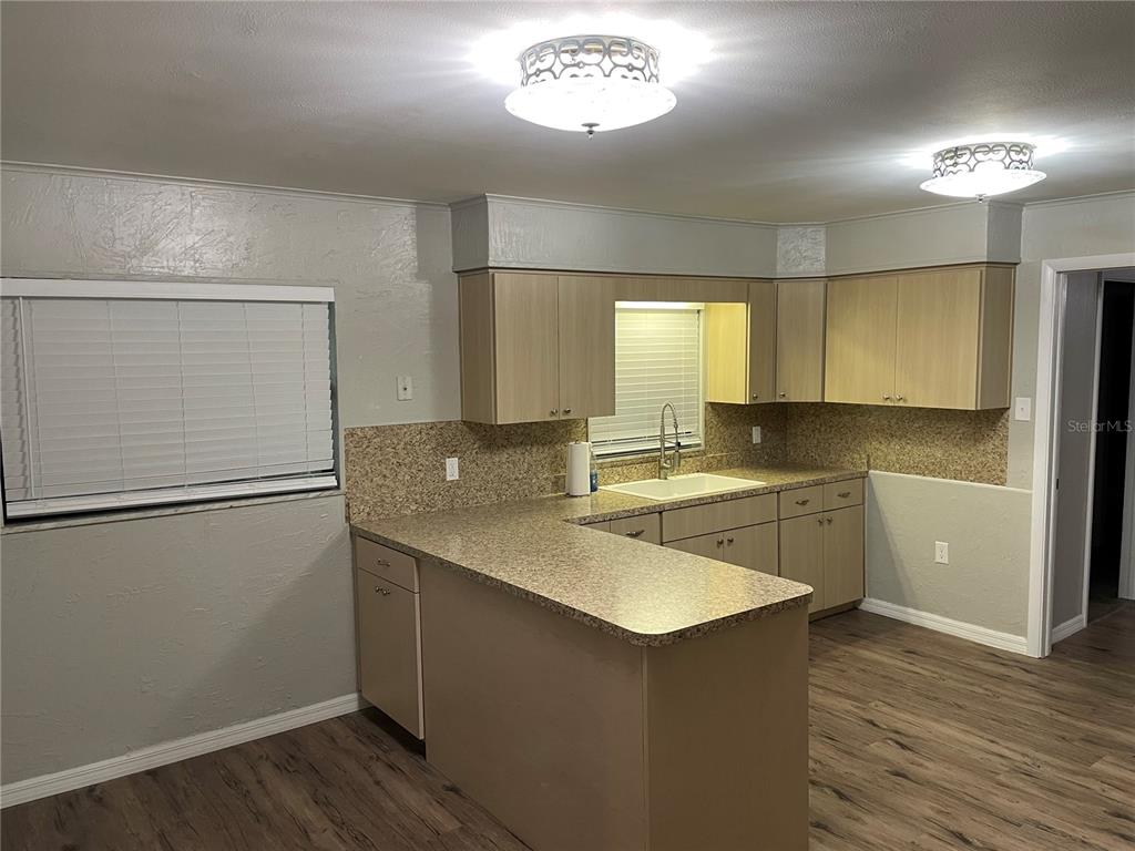 3267 Rackley Road Brooksville, FL 34604 - Photo 9 of 23 a kitchen with a refrigerator sink and cabinets