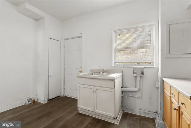 a kitchen with sink a stove and cabinets