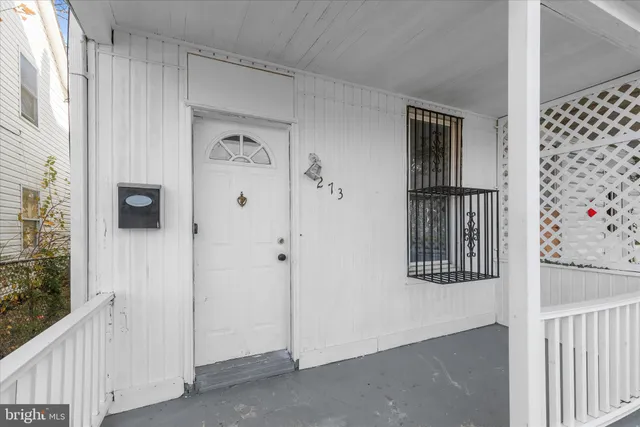 a view of a hallway with wooden floor and entryway