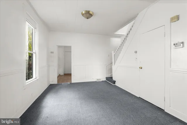 a view of a room with furniture and wooden floor