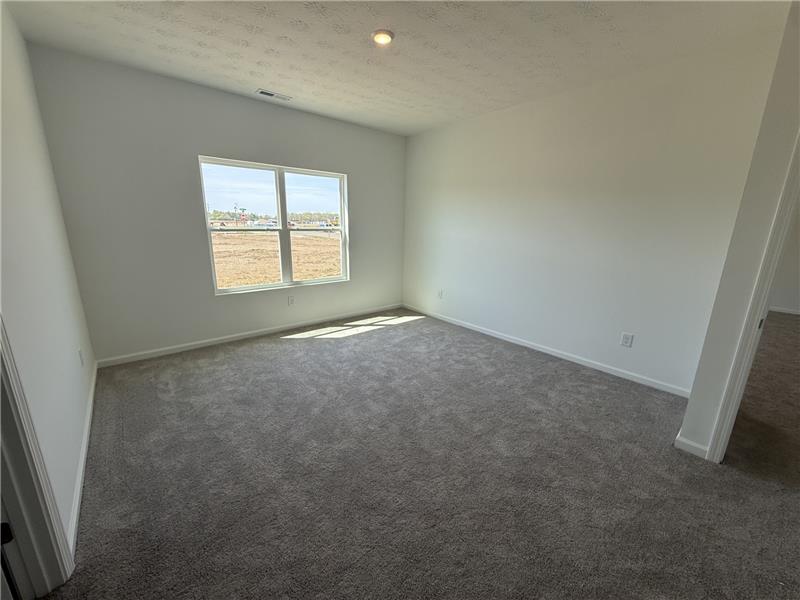 4001 Chakeres Avenue Springfield, OH 45505 - Photo 9 of 15 This versatile room offers plush carpeting and a large window, perfect for various uses.
