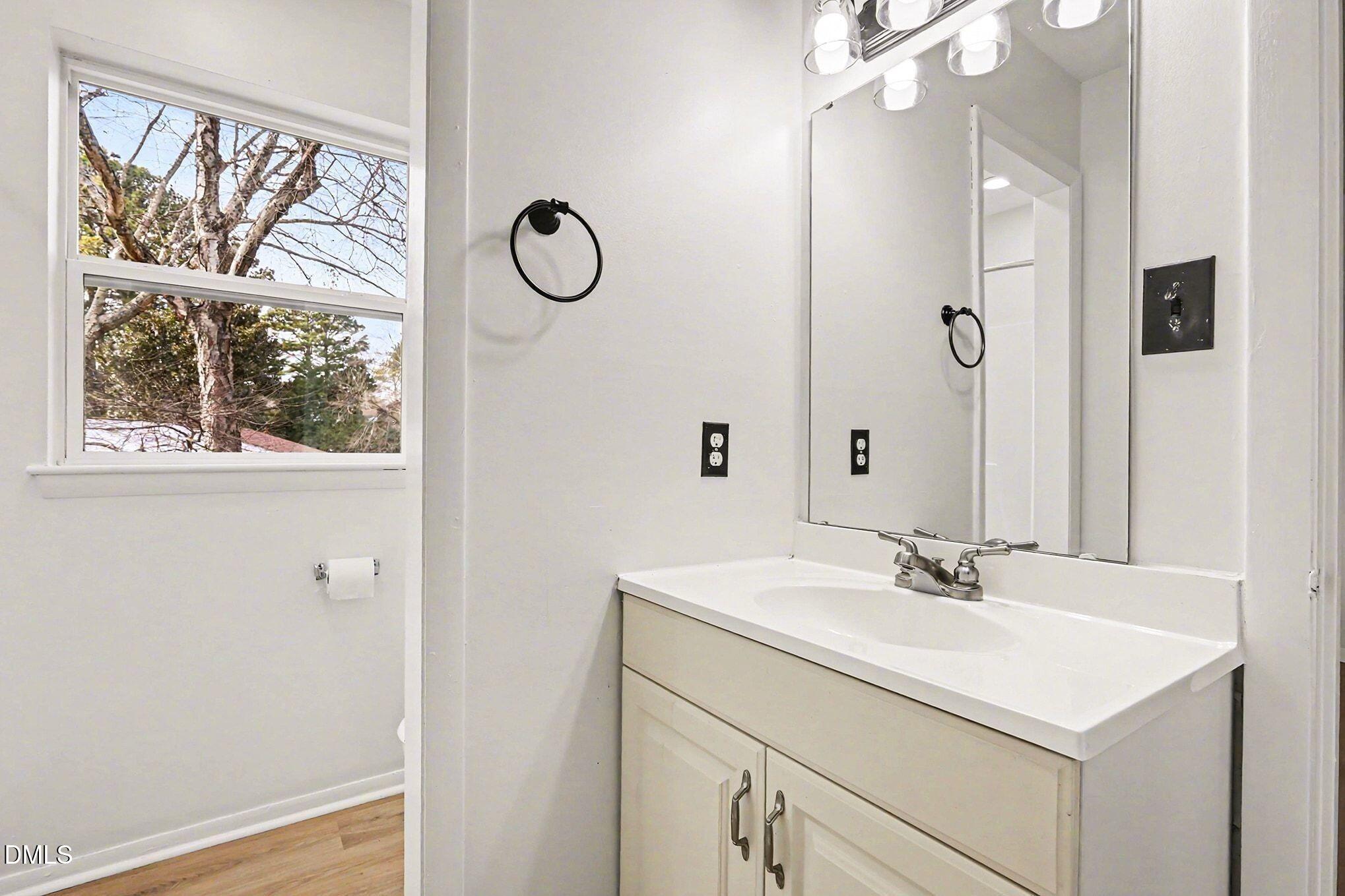 5612 Falls Of Neuse Road, Unit H Raleigh, NC 27609 - Photo 12 of 14 a bathroom with a sink and a mirror