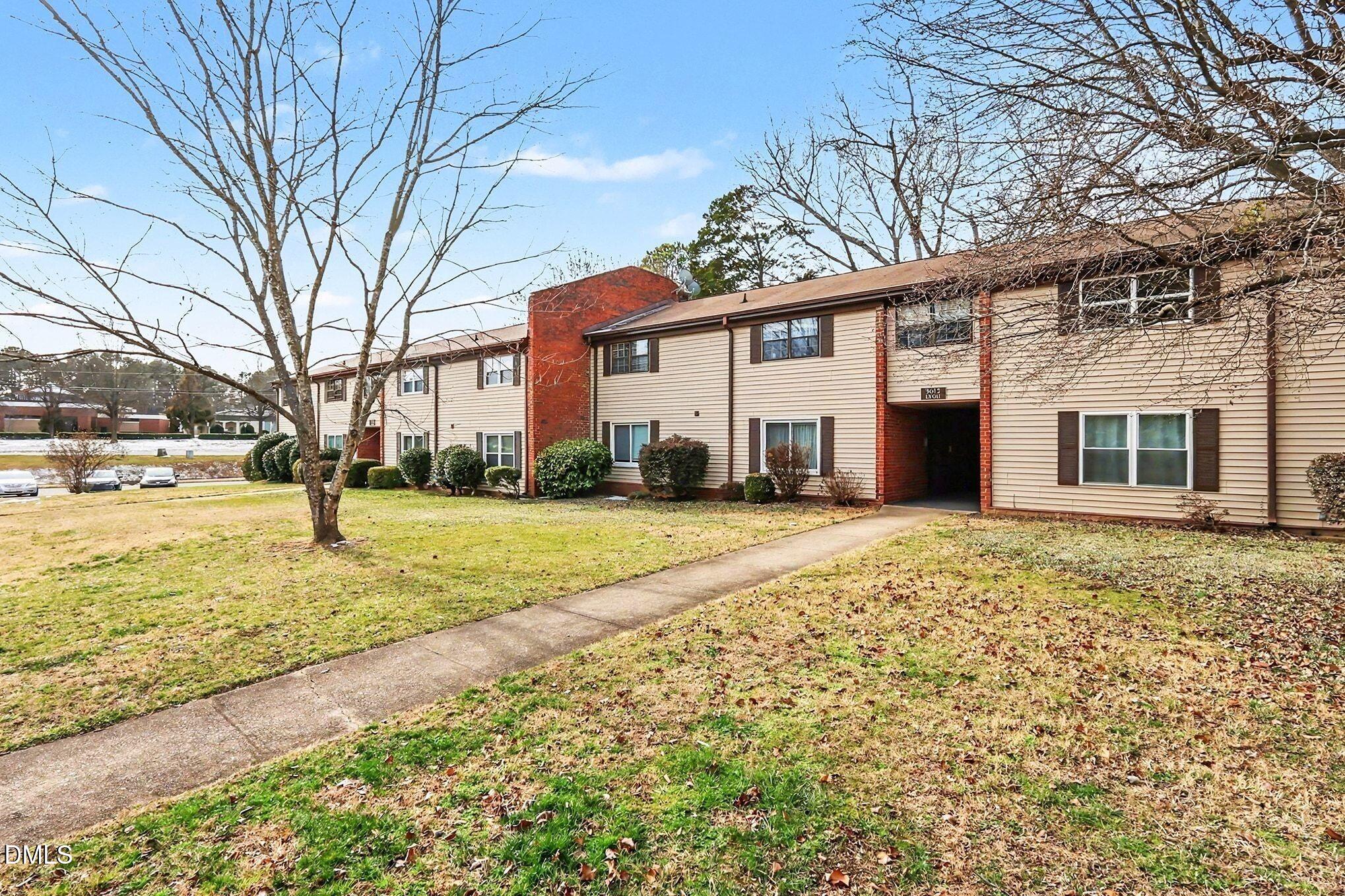 5612 Falls Of Neuse Road, Unit H Raleigh, NC 27609 - Photo 2 of 14 a front view of a house with a yard