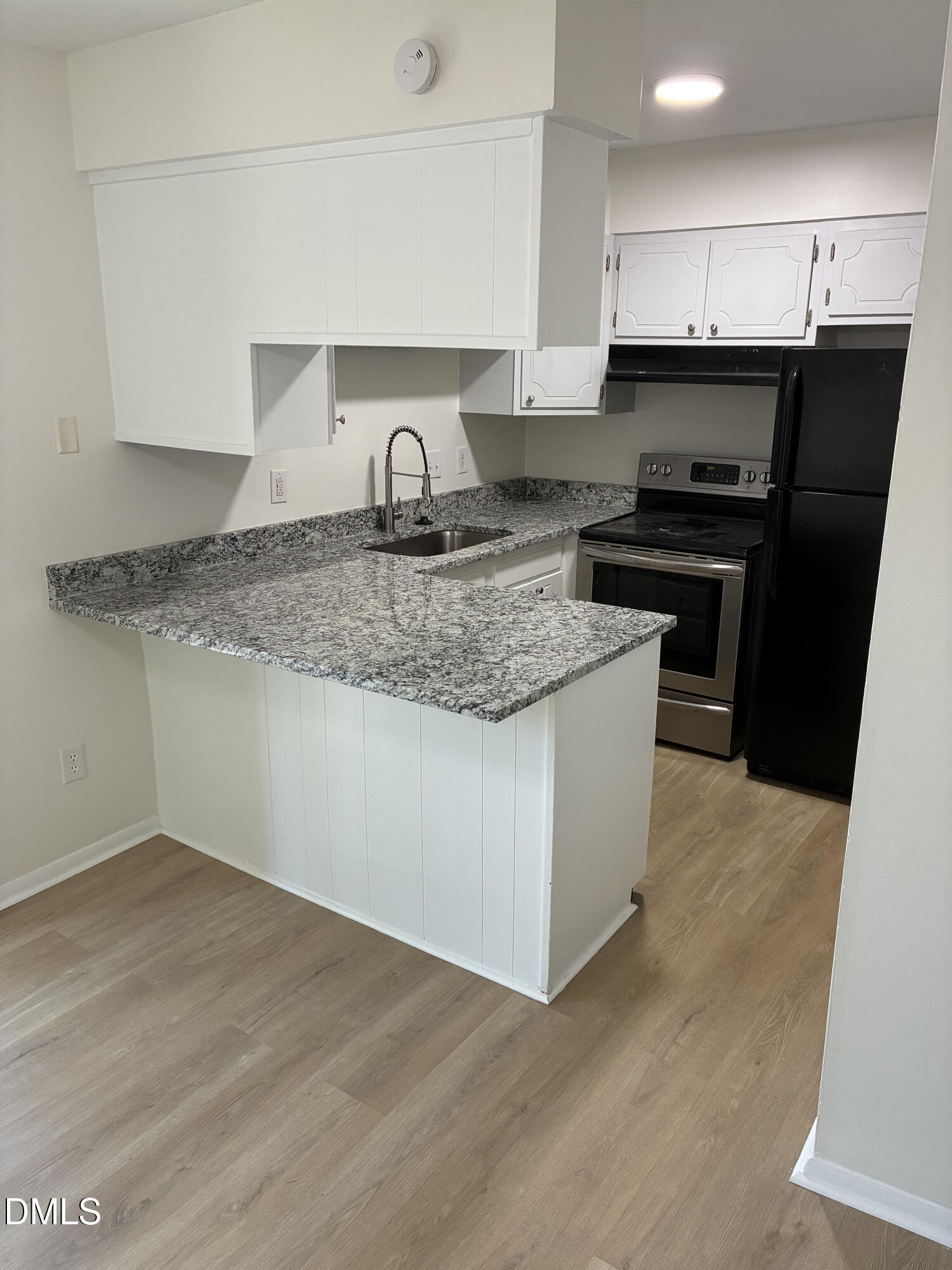 5612 Falls Of Neuse Road, Unit H Raleigh, NC 27609 - Photo 6 of 14 a kitchen with a sink a stove and a refrigerator