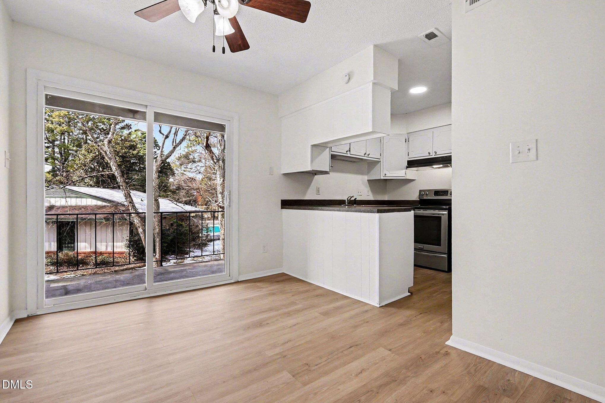 5612 Falls Of Neuse Road, Unit H Raleigh, NC 27609 - Photo 6 of 14 a kitchen with stainless steel appliances granite countertop a stove and a refrigerator