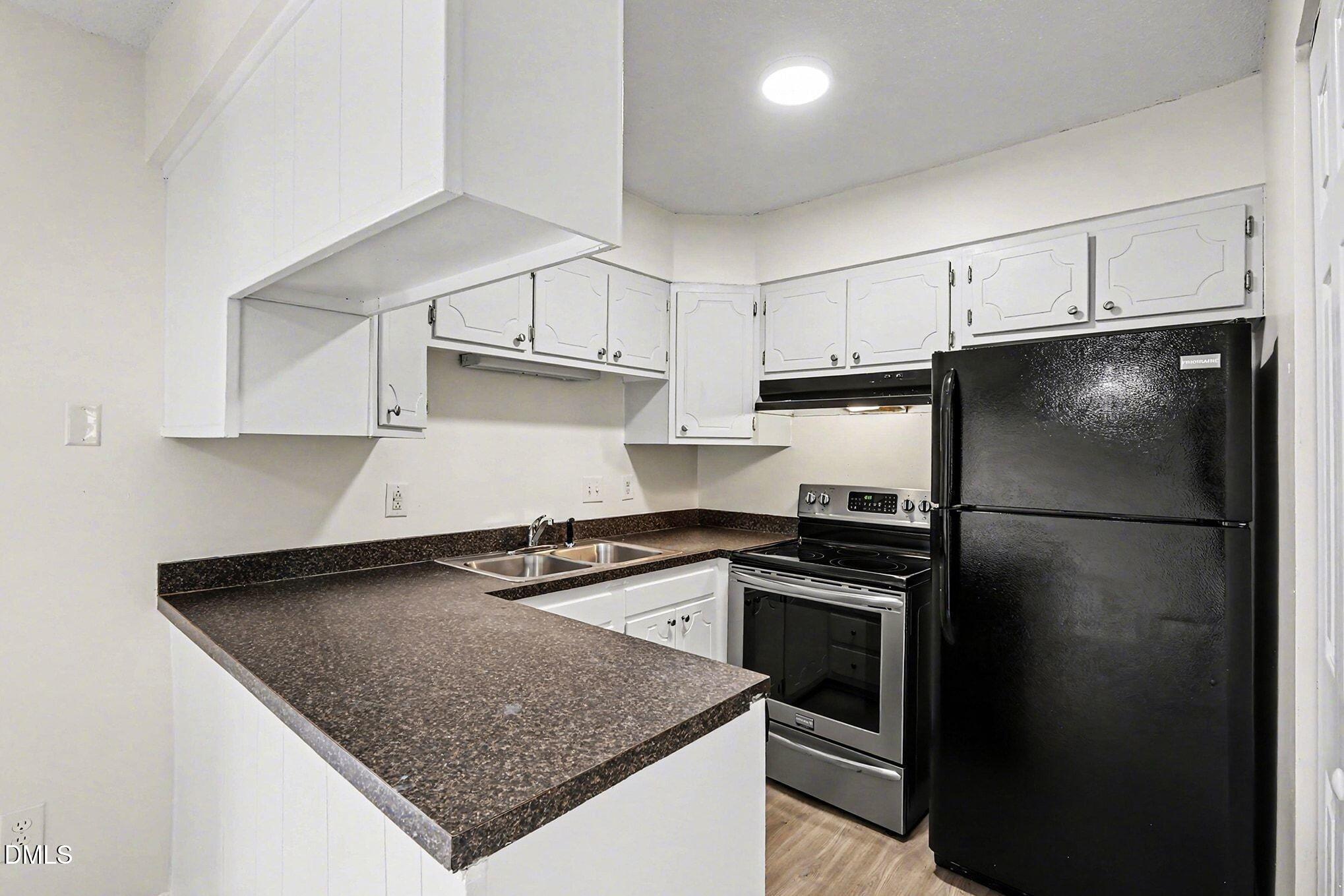 5612 Falls Of Neuse Road, Unit H Raleigh, NC 27609 - Photo 7 of 14 a kitchen with a refrigerator and a sink