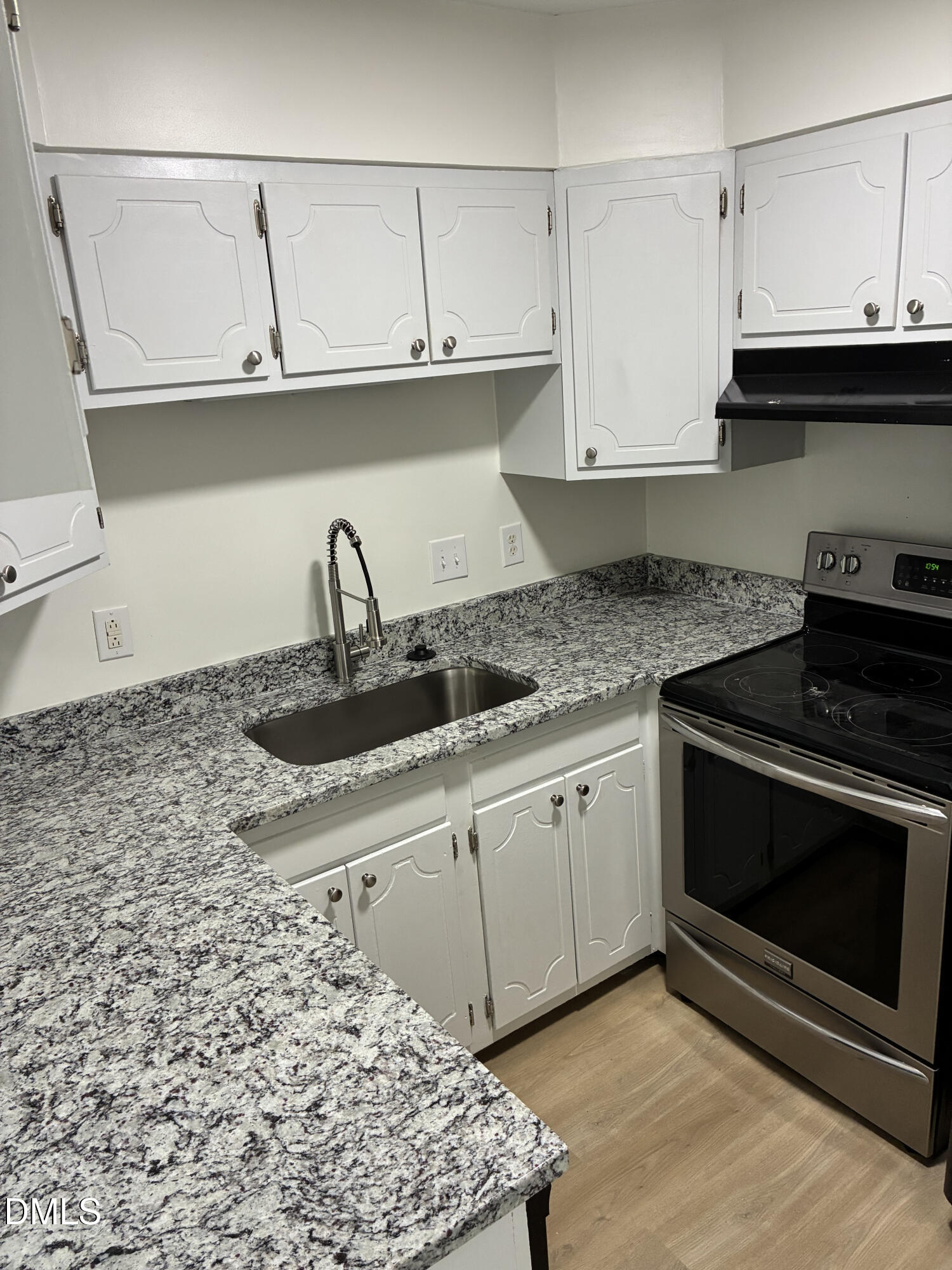 5612 Falls Of Neuse Road, Unit H Raleigh, NC 27609 - Photo 7 of 14 a kitchen with granite countertop a stove sink and cabinets