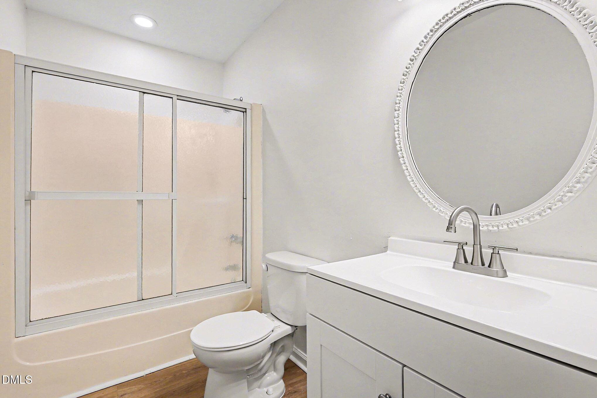 5612 Falls Of Neuse Road, Unit H Raleigh, NC 27609 - Photo 8 of 14 a bathroom with a sink and a mirror