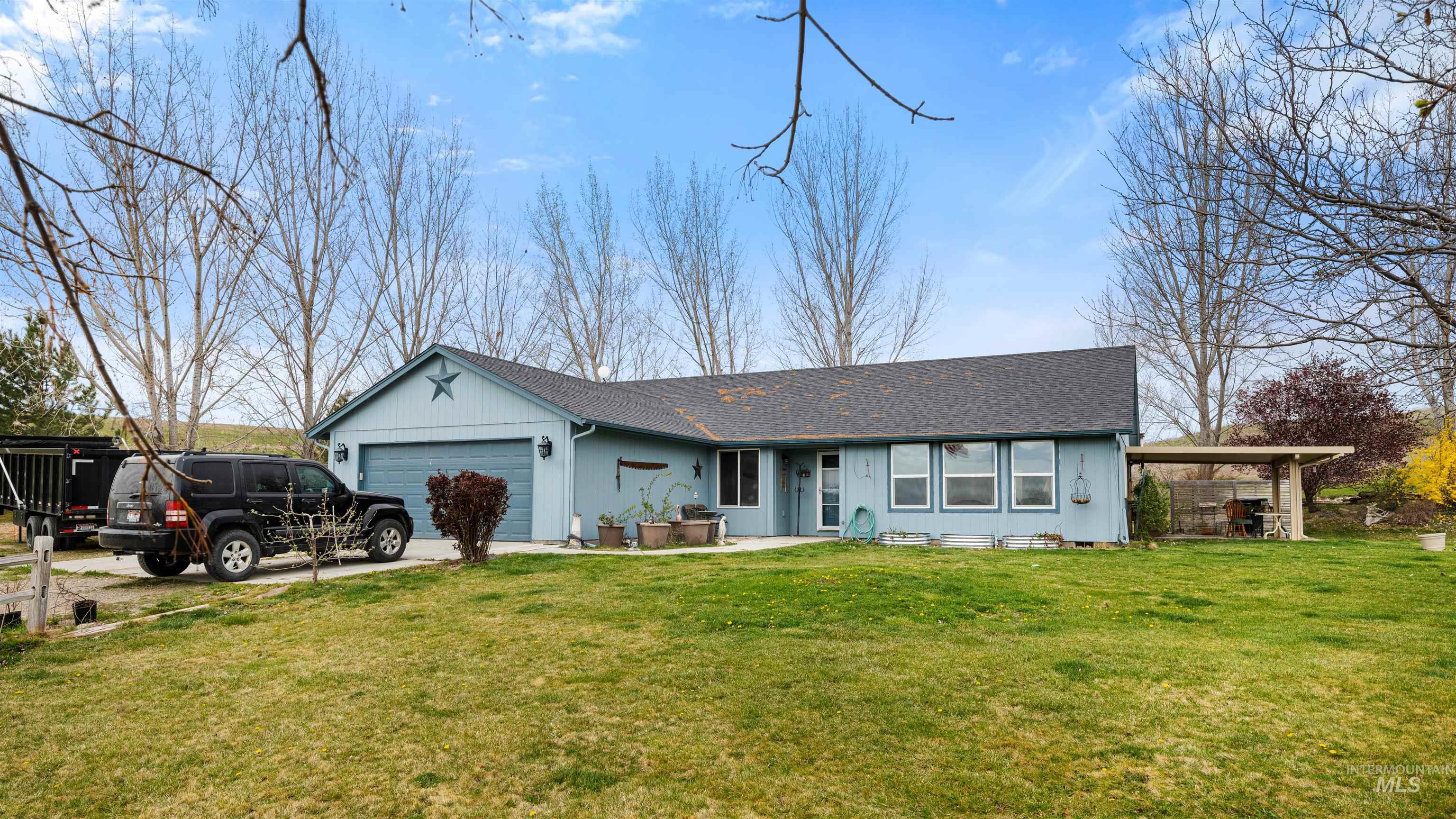 731 Tower Lane Caldwell, ID 83607 - Photo 12 of 38 Ranch-style house with roof with shingles, a front lawn, and a garage