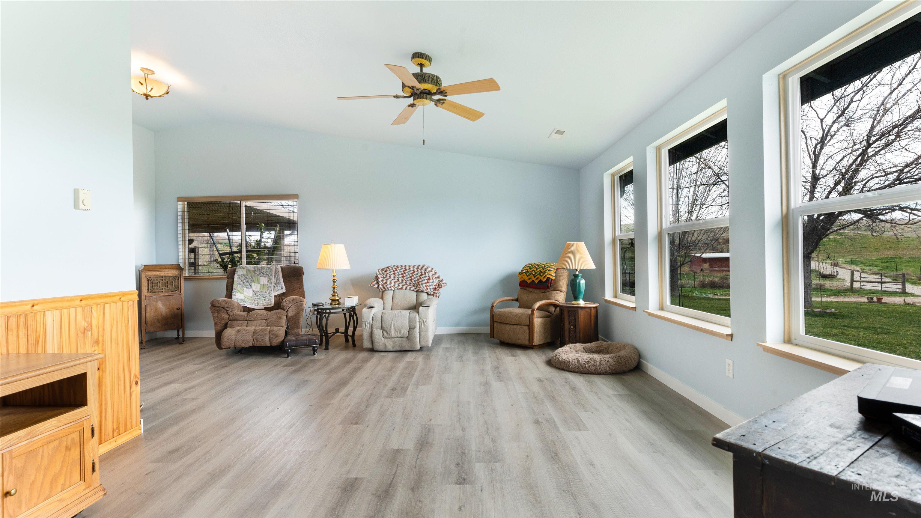 731 Tower Lane Caldwell, ID 83607 - Photo 19 of 38 Living area featuring a ceiling fan, light wood-style flooring, plenty of natural light, and lofted ceiling