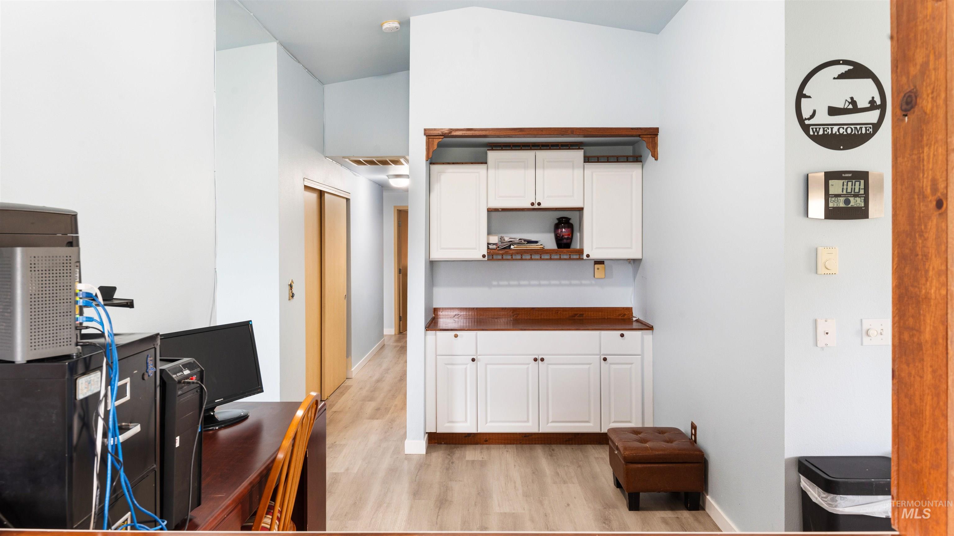 731 Tower Lane Caldwell, ID 83607 - Photo 21 of 38 Kitchen featuring white cabinetry, an office area, light wood-style flooring, and open shelves