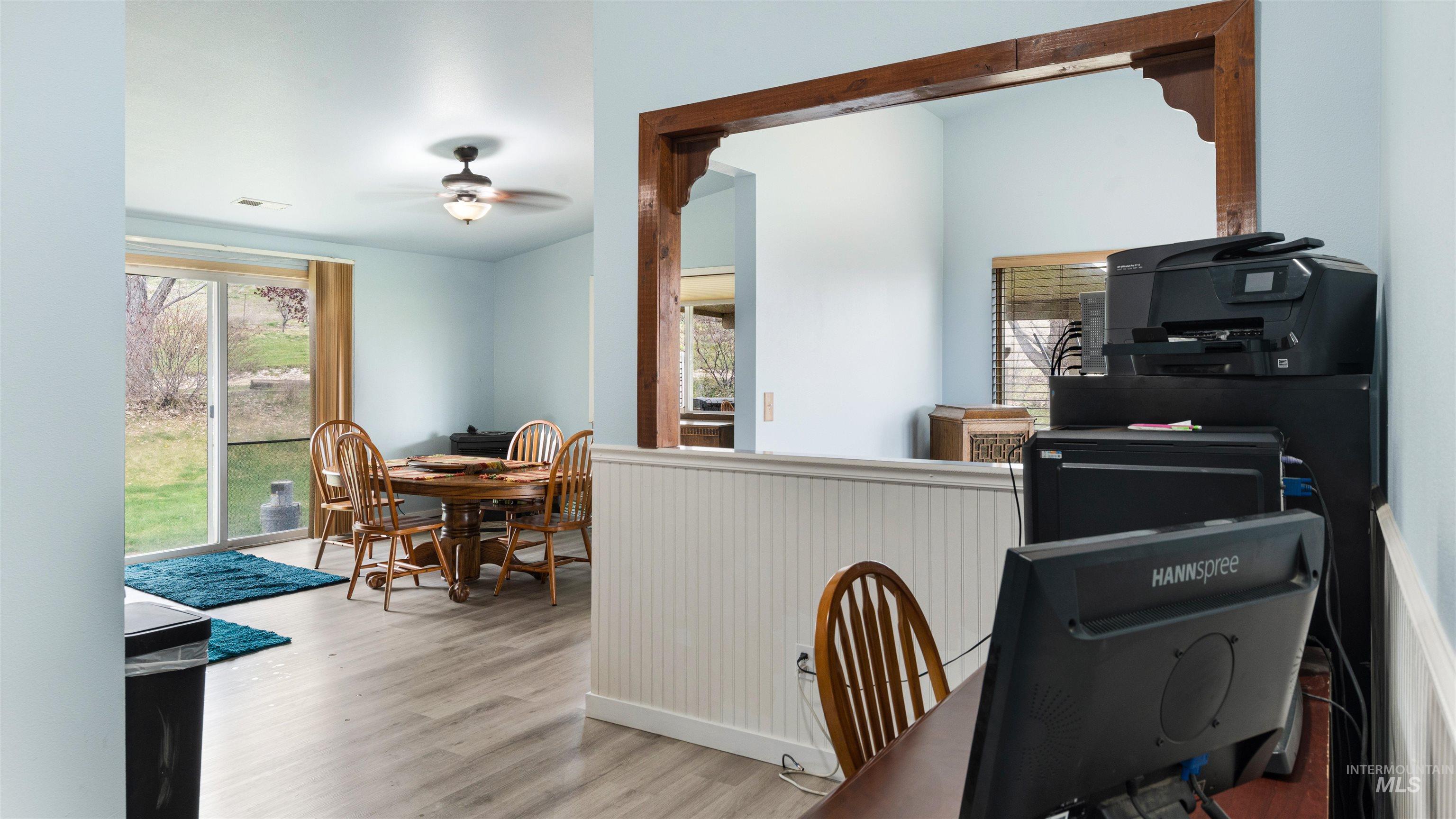 731 Tower Lane Caldwell, ID 83607 - Photo 22 of 38 Kitchen featuring ceiling fan, light wood-style flooring, and wainscoting