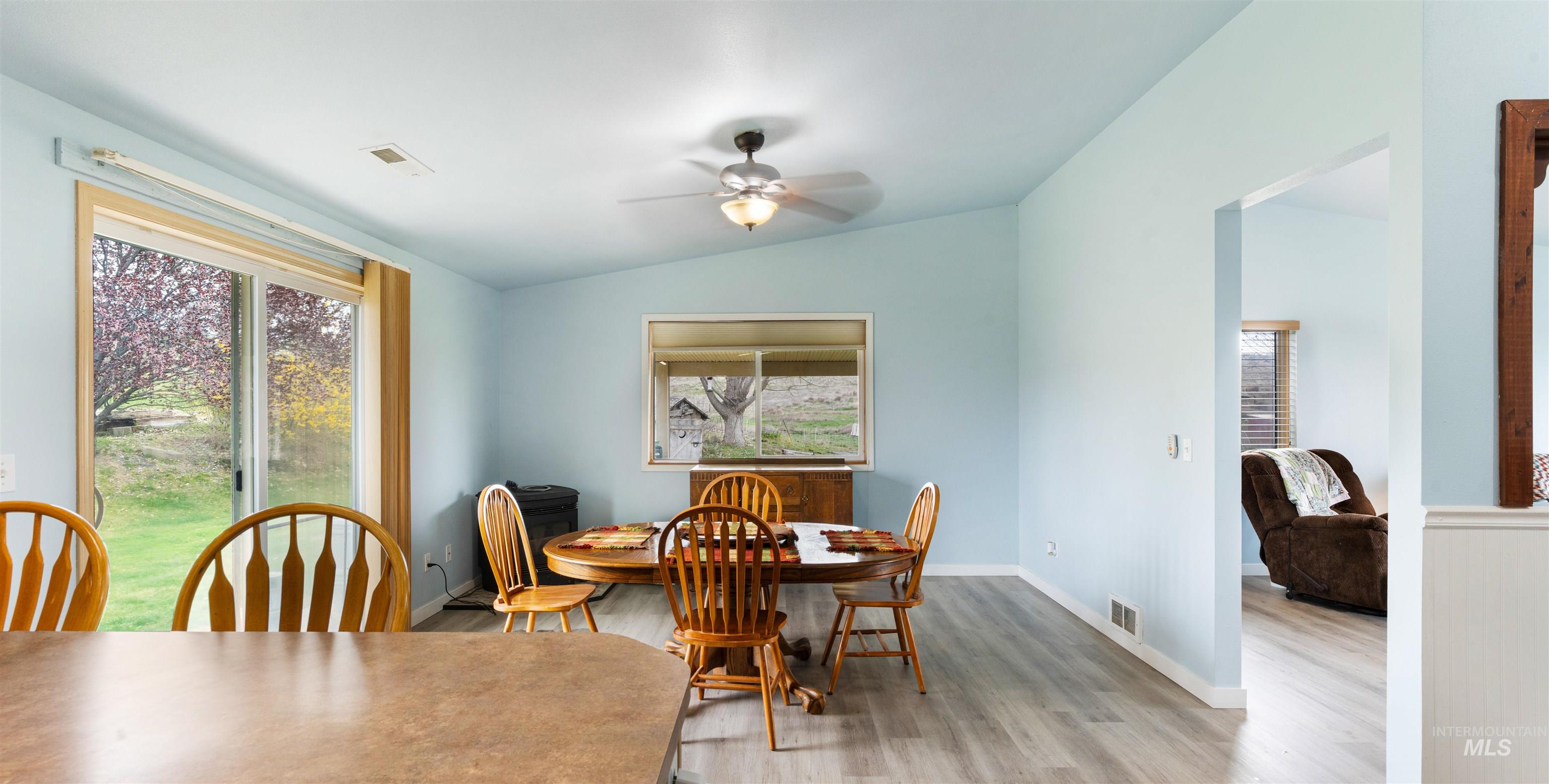 731 Tower Lane Caldwell, ID 83607 - Photo 24 of 38 Dining space featuring lofted ceiling, ceiling fan, light wood finished floors, and plenty of natural light