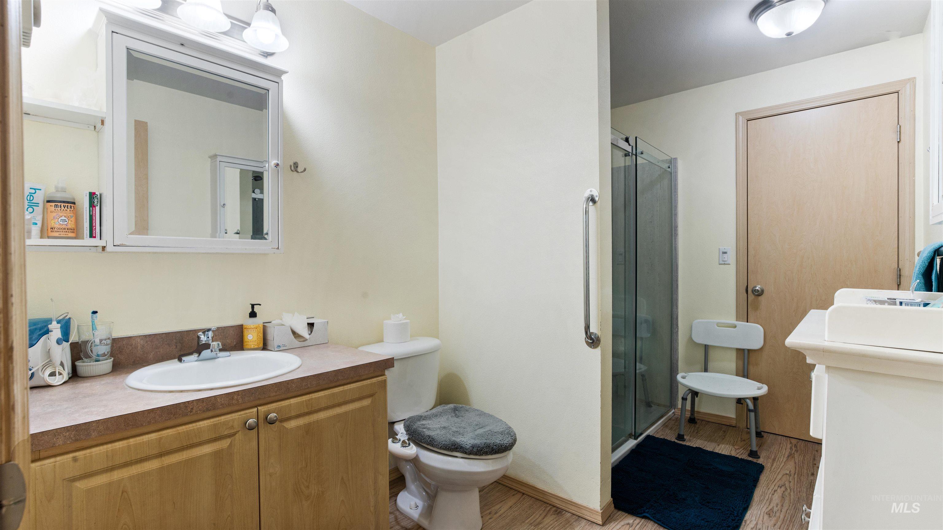 731 Tower Lane Caldwell, ID 83607 - Photo 30 of 38 Full bath with vanity, a shower stall, and light wood-type flooring