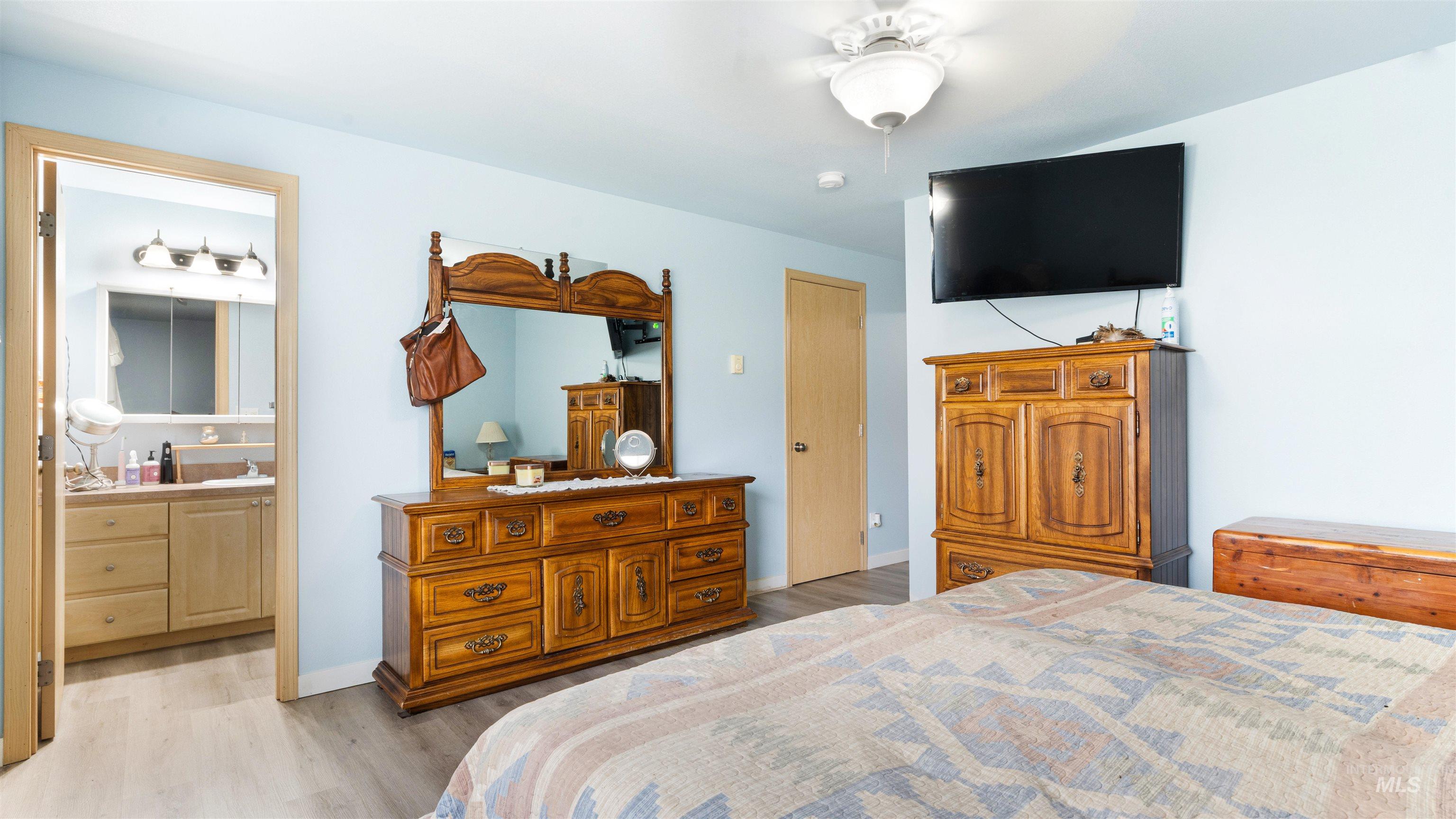 731 Tower Lane Caldwell, ID 83607 - Photo 32 of 38 Bedroom featuring light wood-style flooring, a ceiling fan, and ensuite bathroom