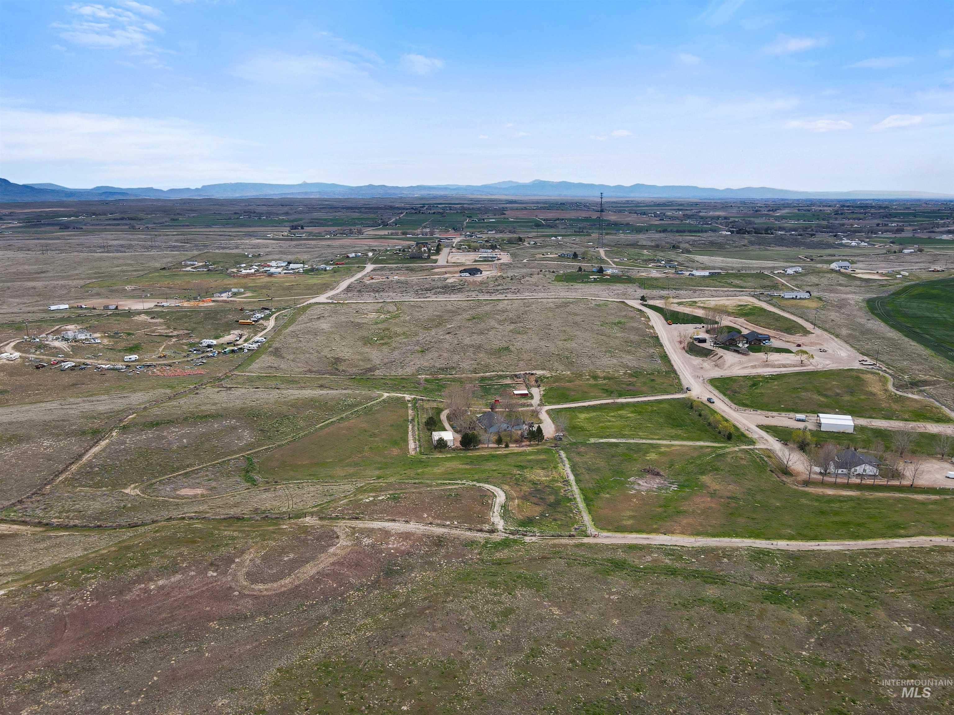731 Tower Lane Caldwell, ID 83607 - Photo 6 of 38 Aerial view of property and surrounding area featuring rural landscape and a mountain backdrop