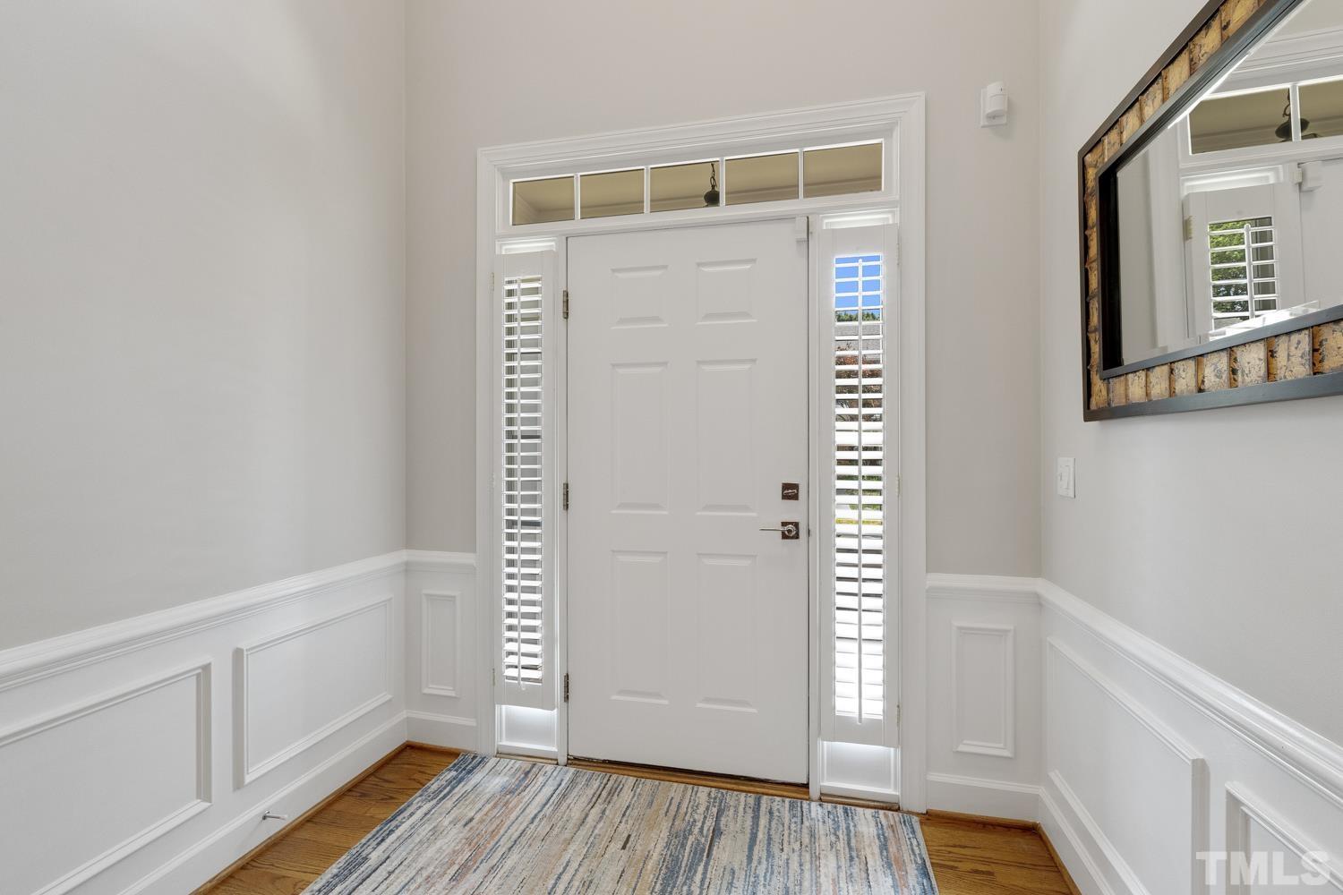 3917 Sunset Maple Court Raleigh, NC 27612 - Photo 18 of 54 a view of an empty room with wooden floor and a window