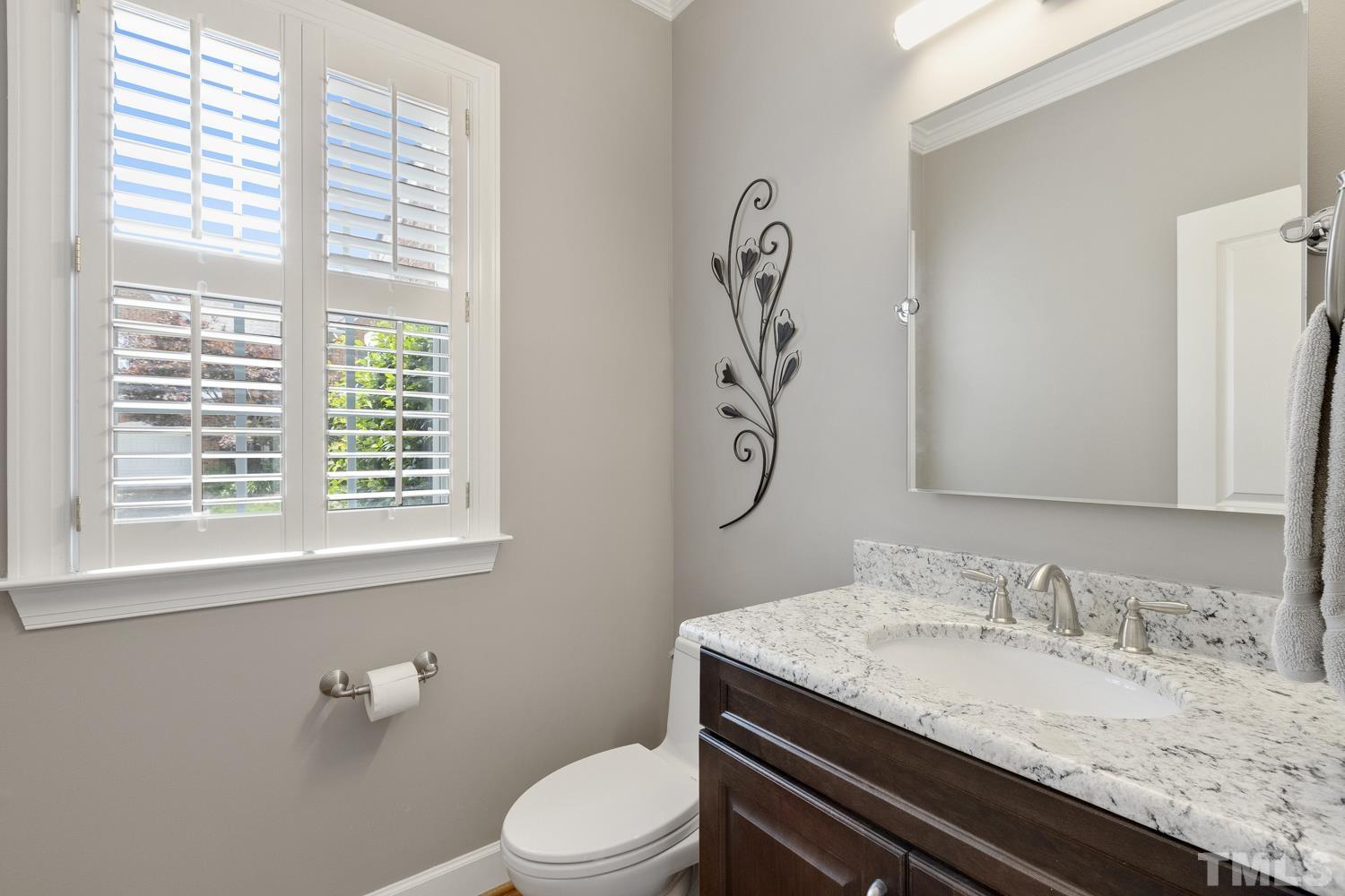 3917 Sunset Maple Court Raleigh, NC 27612 - Photo 19 of 54 a bathroom with a granite countertop sink a toilet and a mirror