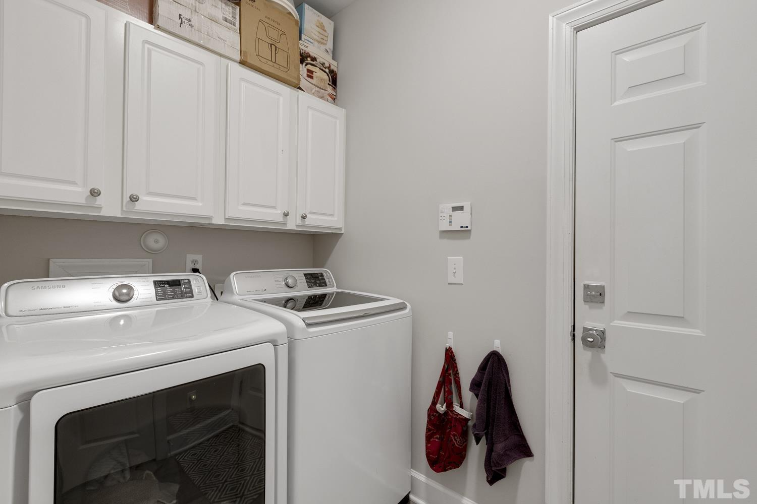 3917 Sunset Maple Court Raleigh, NC 27612 - Photo 35 of 54 a utility room with dryer and washer