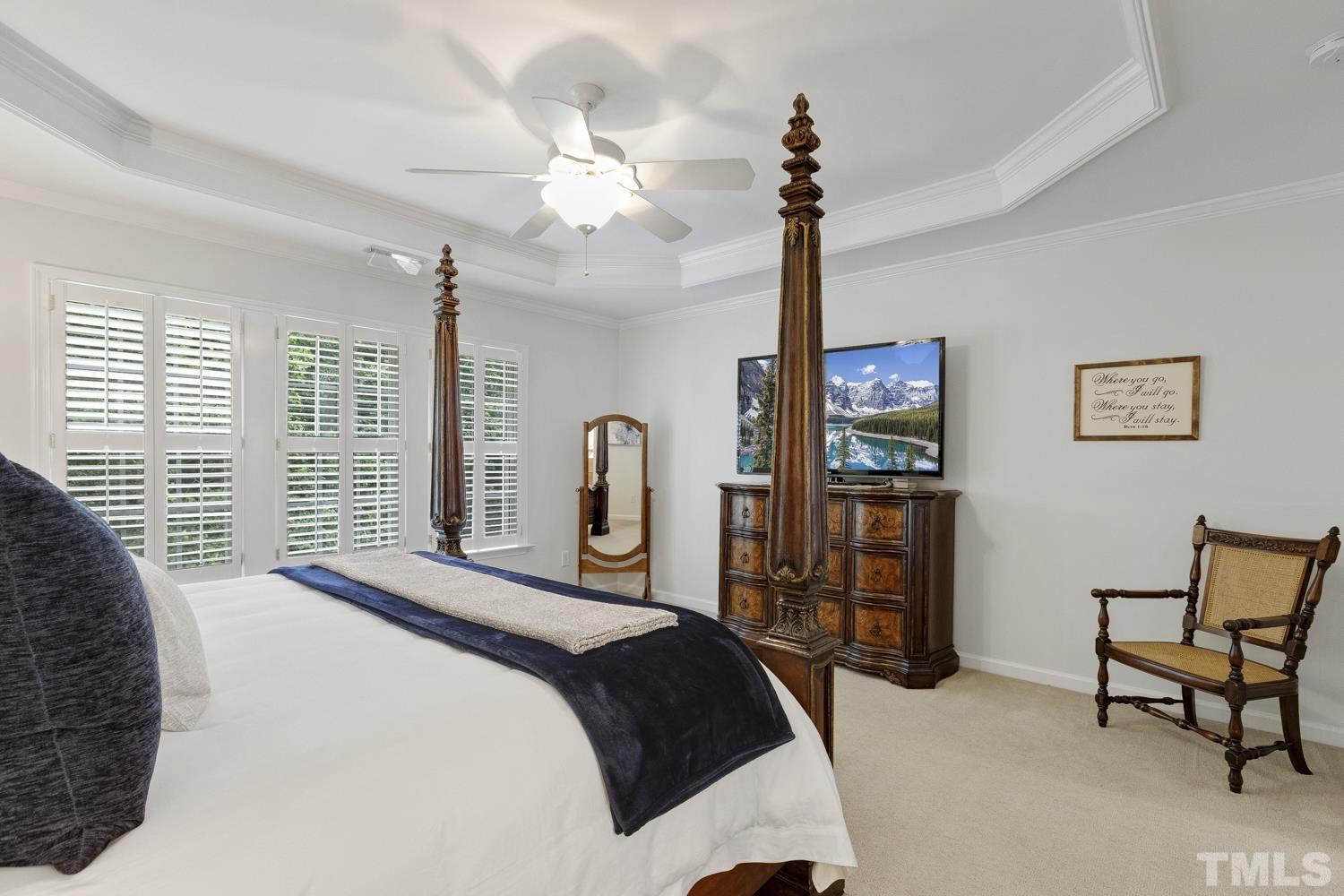 3917 Sunset Maple Court Raleigh, NC 27612 - Photo 42 of 54 a bedroom with a bed and a chandelier