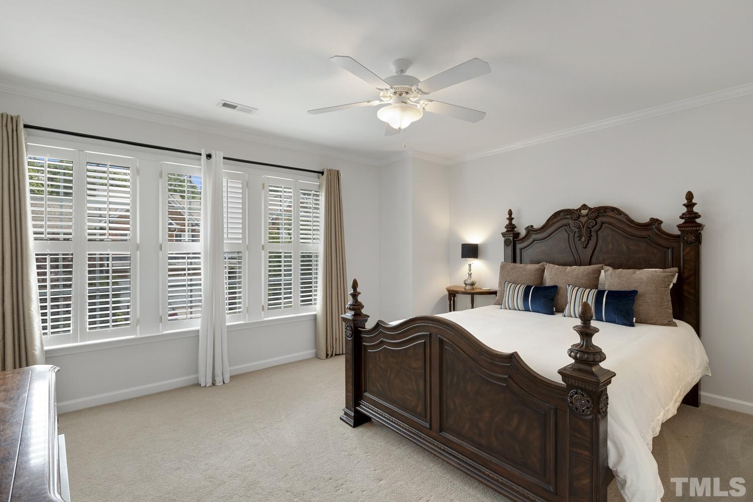 3917 Sunset Maple Court Raleigh, NC 27612 - Photo 50 of 54 a bed room with a bed and a chandelier