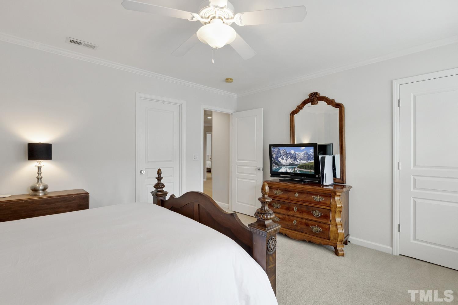 3917 Sunset Maple Court Raleigh, NC 27612 - Photo 51 of 54 a bedroom with a bed and a television