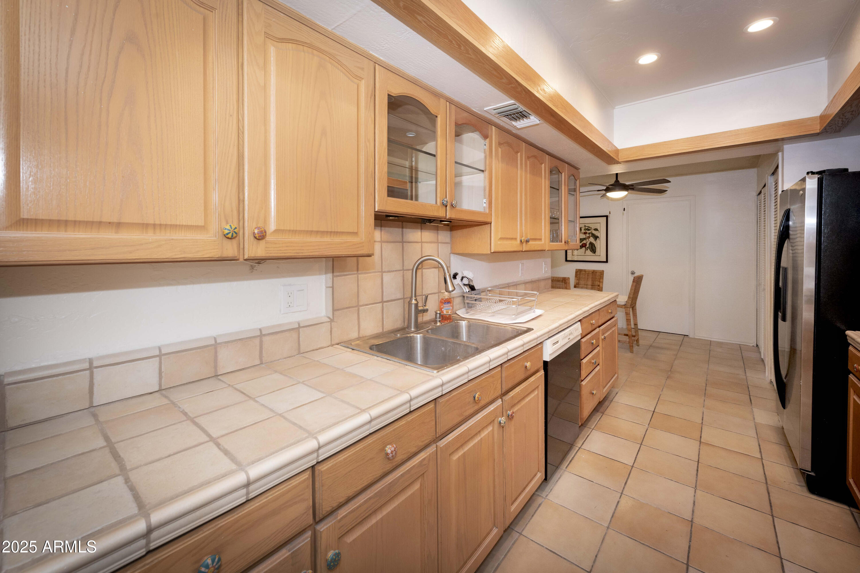 4446 East Camelback Road, Unit 109 Phoenix, AZ 85018 - Photo 14 of 42 a kitchen with a sink and a refrigerator