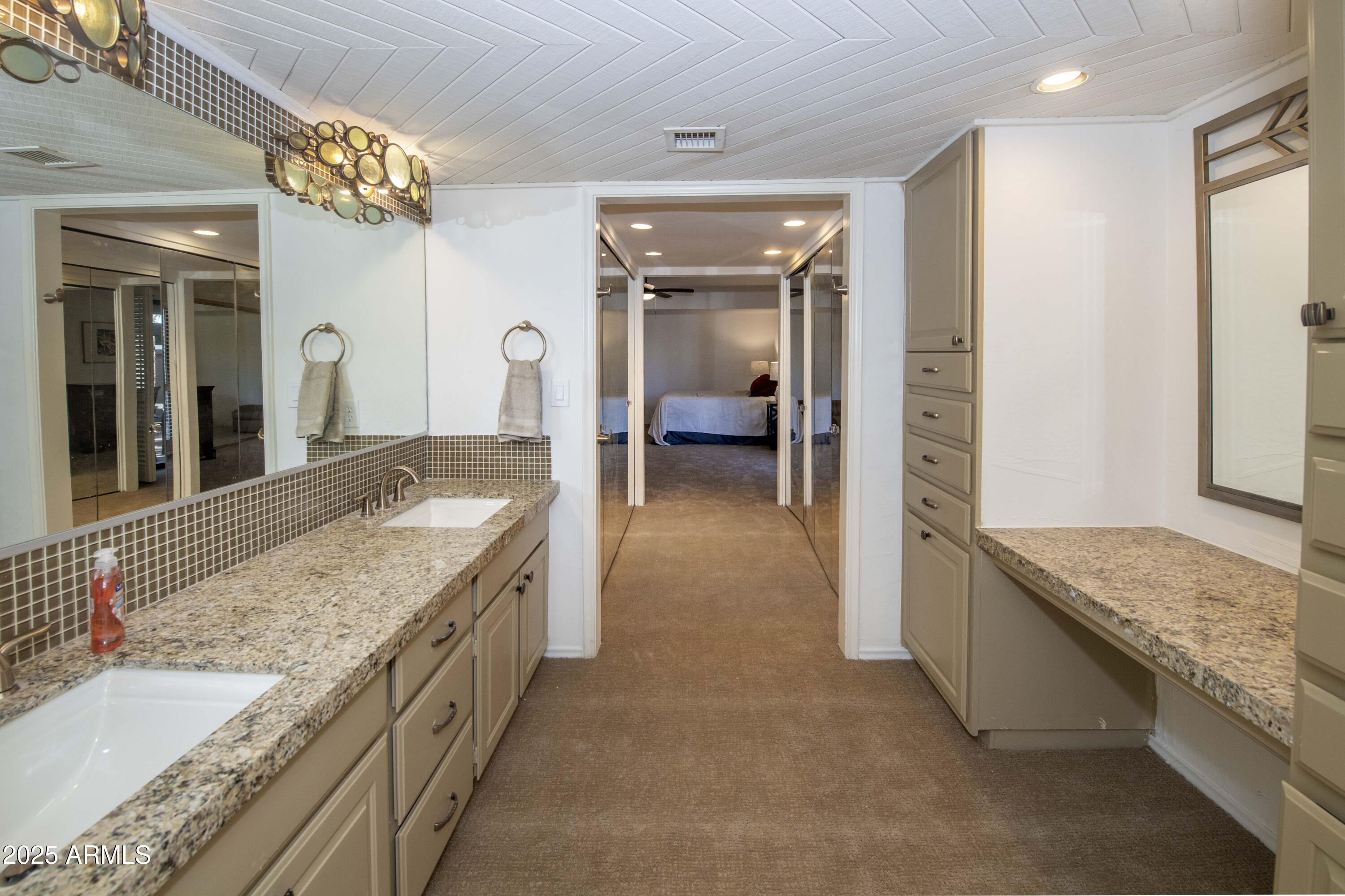 4446 East Camelback Road, Unit 109 Phoenix, AZ 85018 - Photo 22 of 42 a spacious en suite bathroom with a granite countertop sink and a mirror