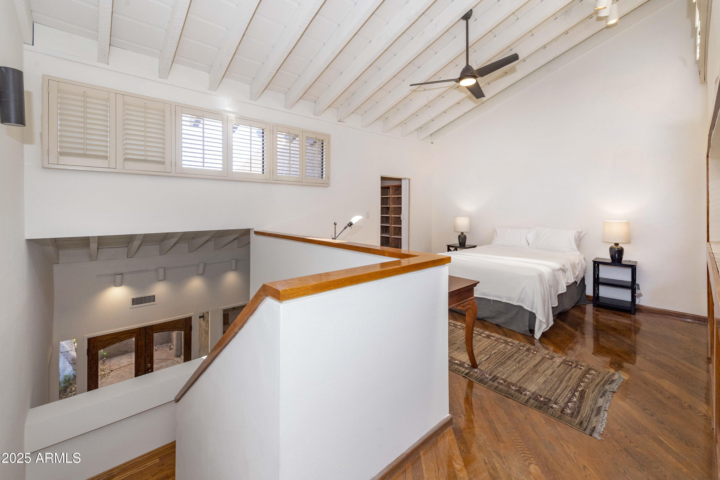 4446 East Camelback Road, Unit 109 Phoenix, AZ 85018 - Photo 27 of 42 a bedroom with a bed and a chandelier