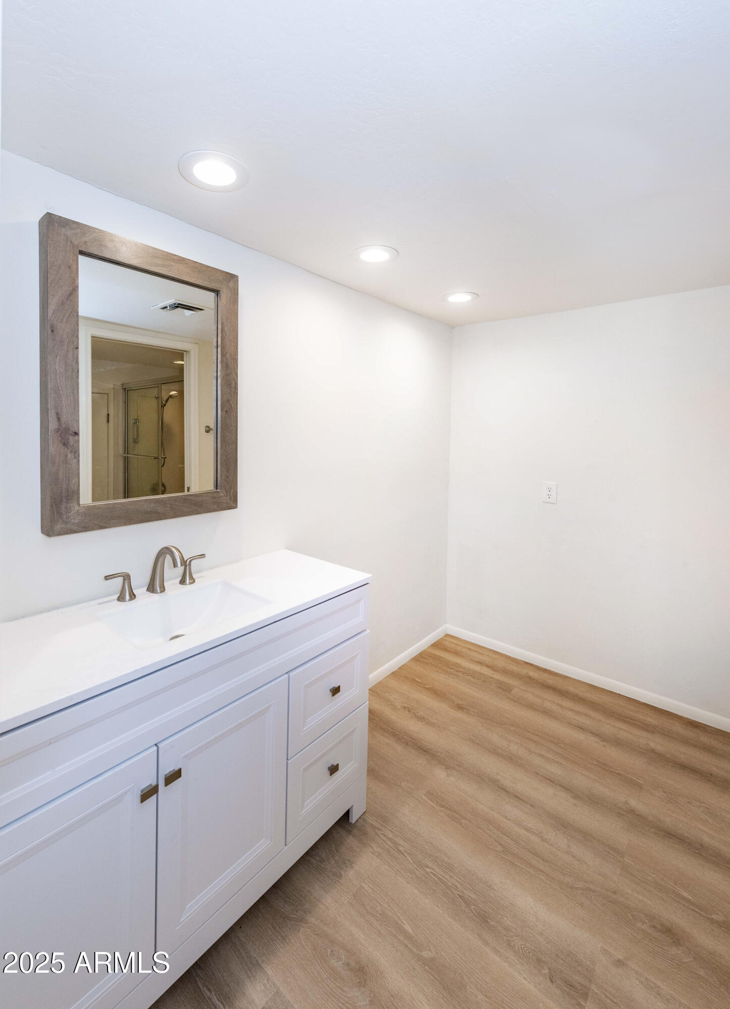 4446 East Camelback Road, Unit 109 Phoenix, AZ 85018 - Photo 32 of 42 a bathroom with a sink and a mirror