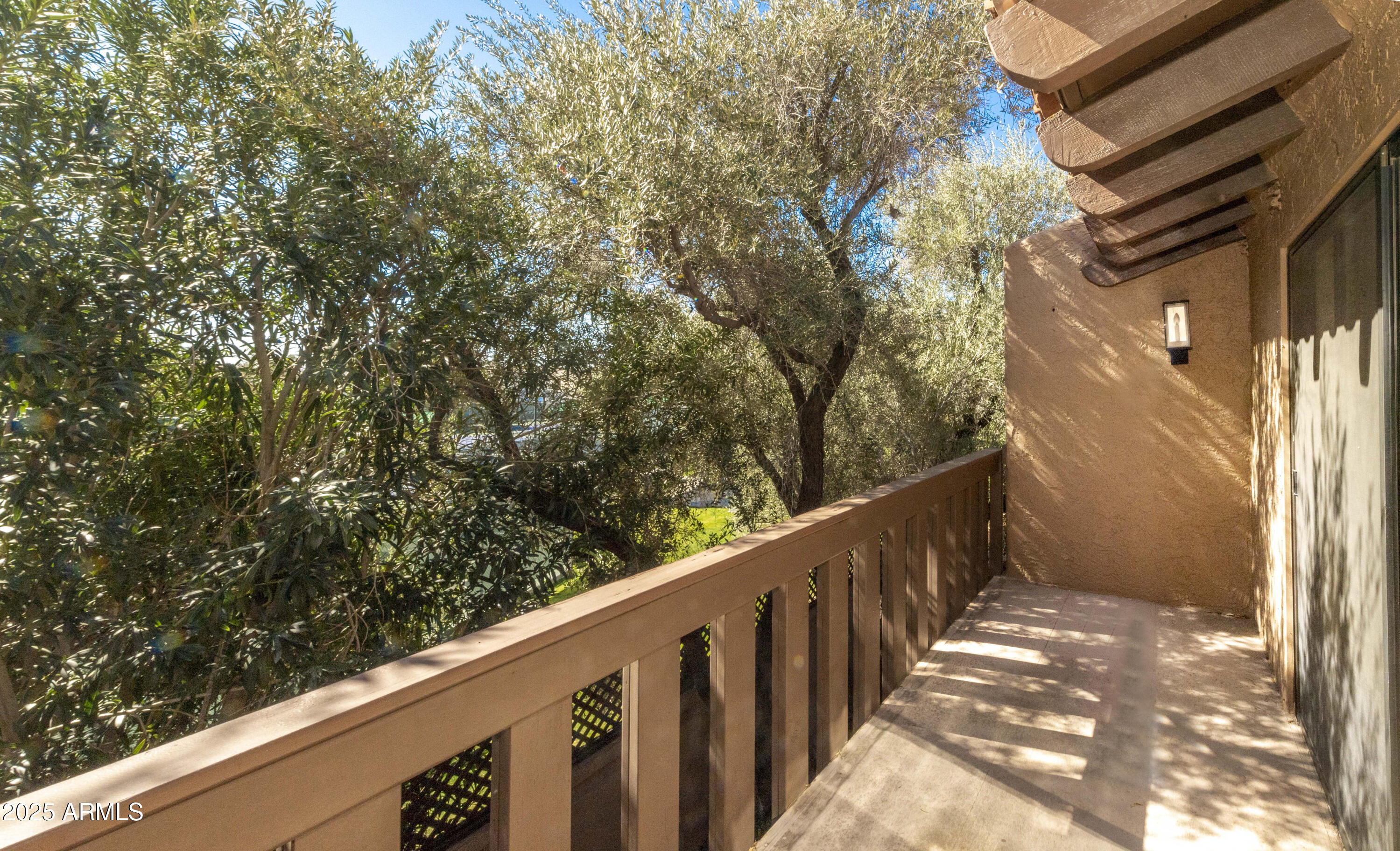 4446 East Camelback Road, Unit 109 Phoenix, AZ 85018 - Photo 37 of 42 a view of a wooden fence from a balcony