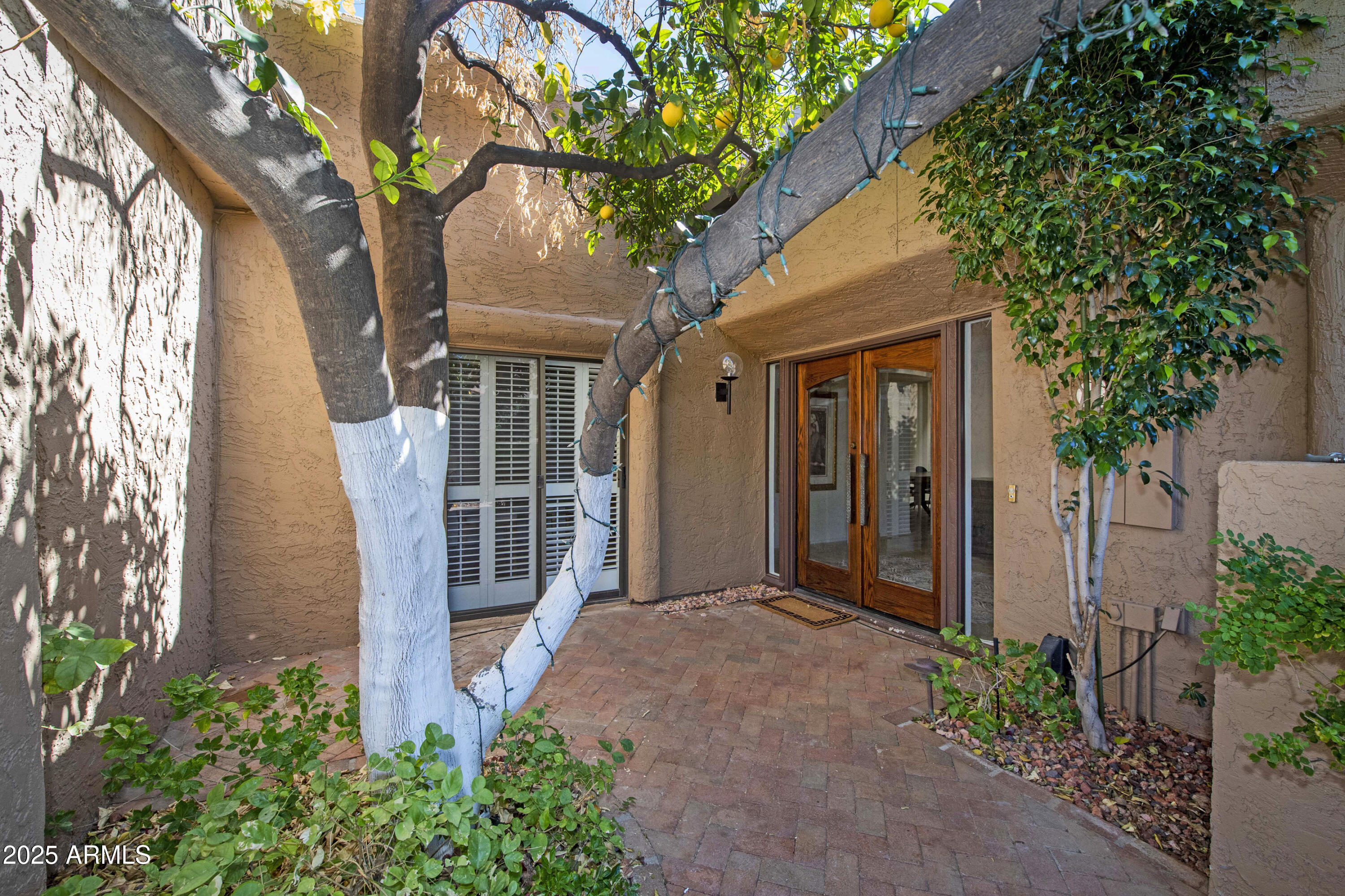 4446 East Camelback Road, Unit 109 Phoenix, AZ 85018 - Photo 5 of 42 a front view of a house with garden