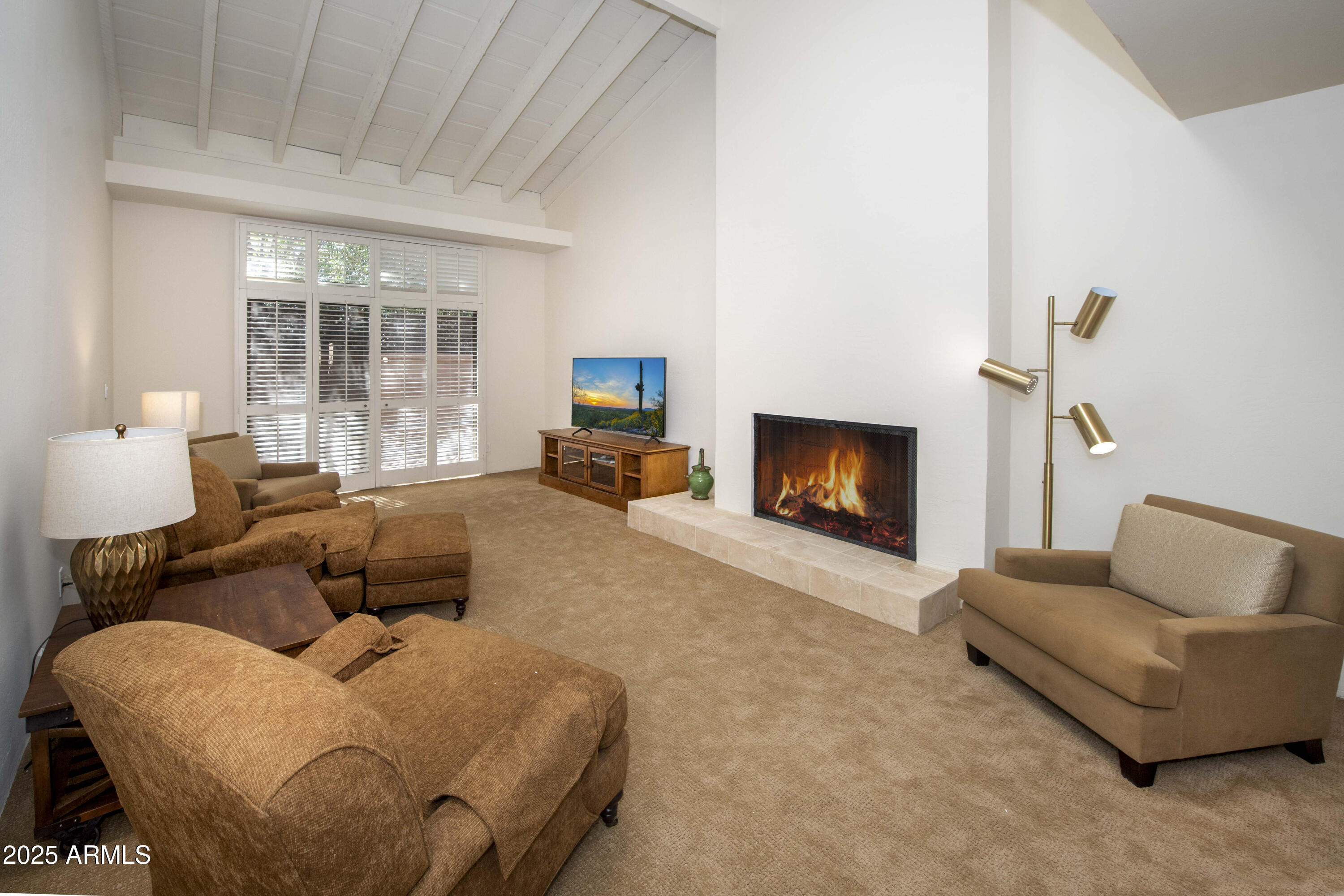 4446 East Camelback Road, Unit 109 Phoenix, AZ 85018 - Photo 8 of 42 a living room with furniture and a fireplace