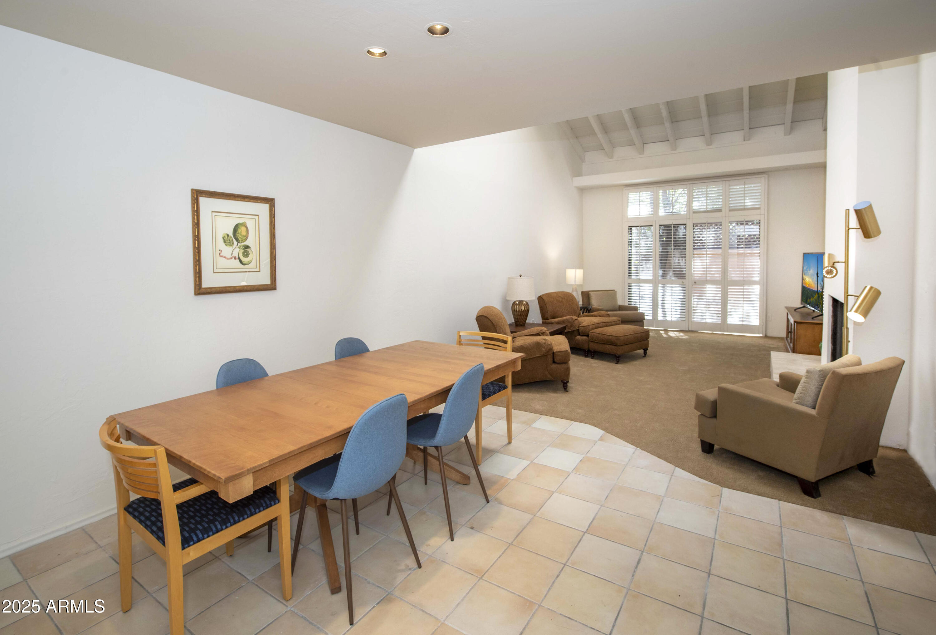 4446 East Camelback Road, Unit 109 Phoenix, AZ 85018 - Photo 9 of 42 a living room with furniture a chandelier and a table