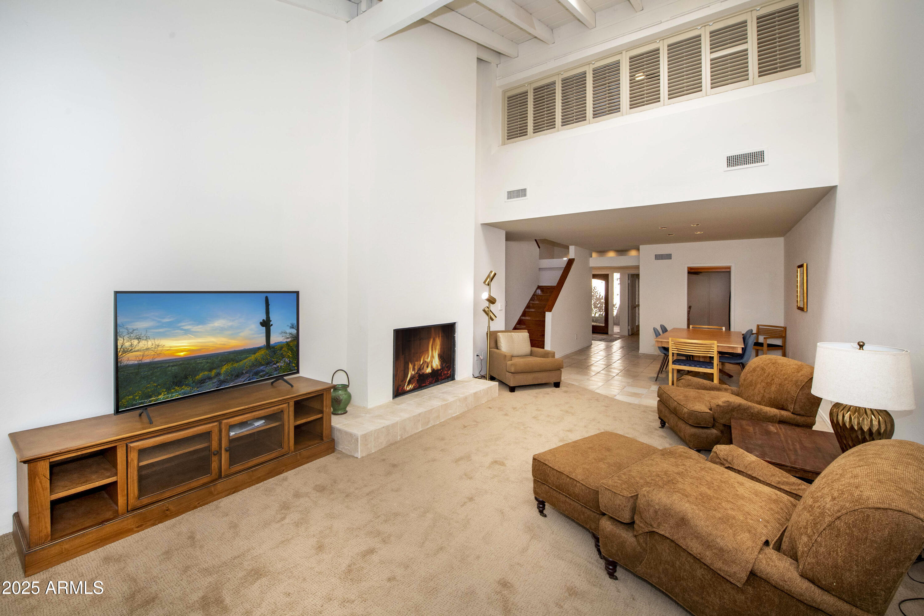 4446 East Camelback Road, Unit 109 Phoenix, AZ 85018 - Photo 10 of 42 a living room with furniture and a flat screen tv