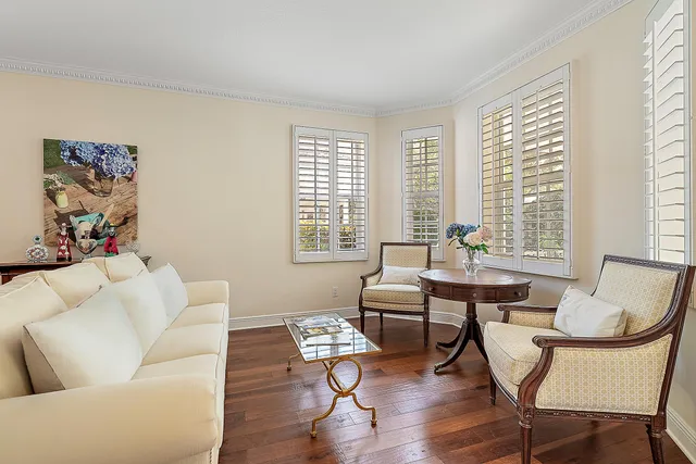 a view of pool with lawn chairs and plants