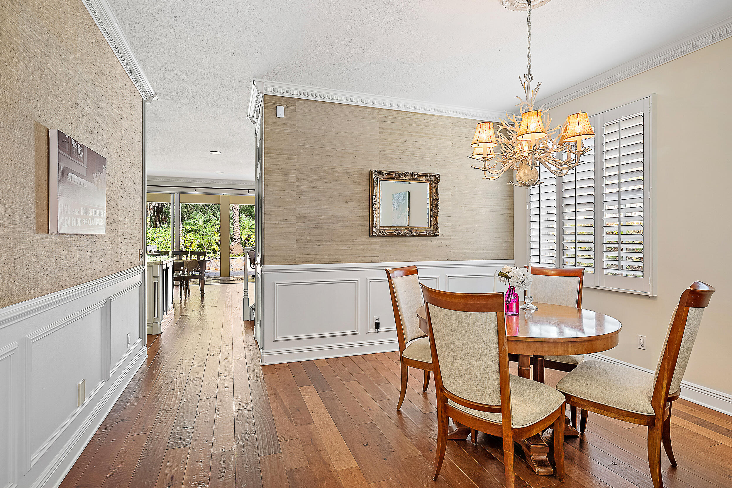 140 Sweet Bay Circle Jupiter, FL 33458 - Photo 20 of 36 a view of a dining room with furniture wooden floor and chandelier