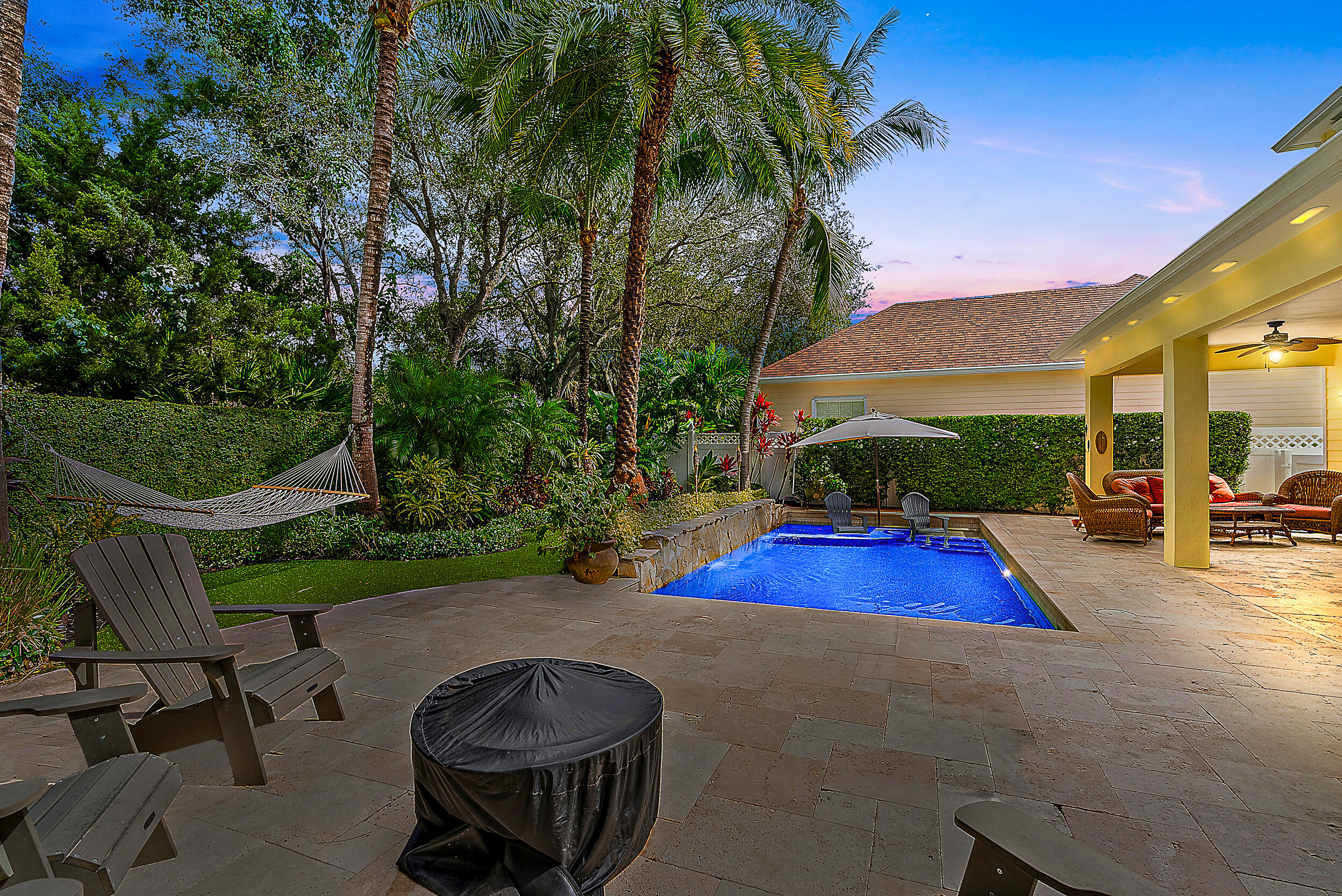 140 Sweet Bay Circle Jupiter, FL 33458 - Photo 3 of 36 a view of backyard with swimming pool and outdoor seating